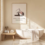 Bathroom interior with a bathtub, plant, and framed artwork on the wall, with text Girls Just Wanna Read Books
