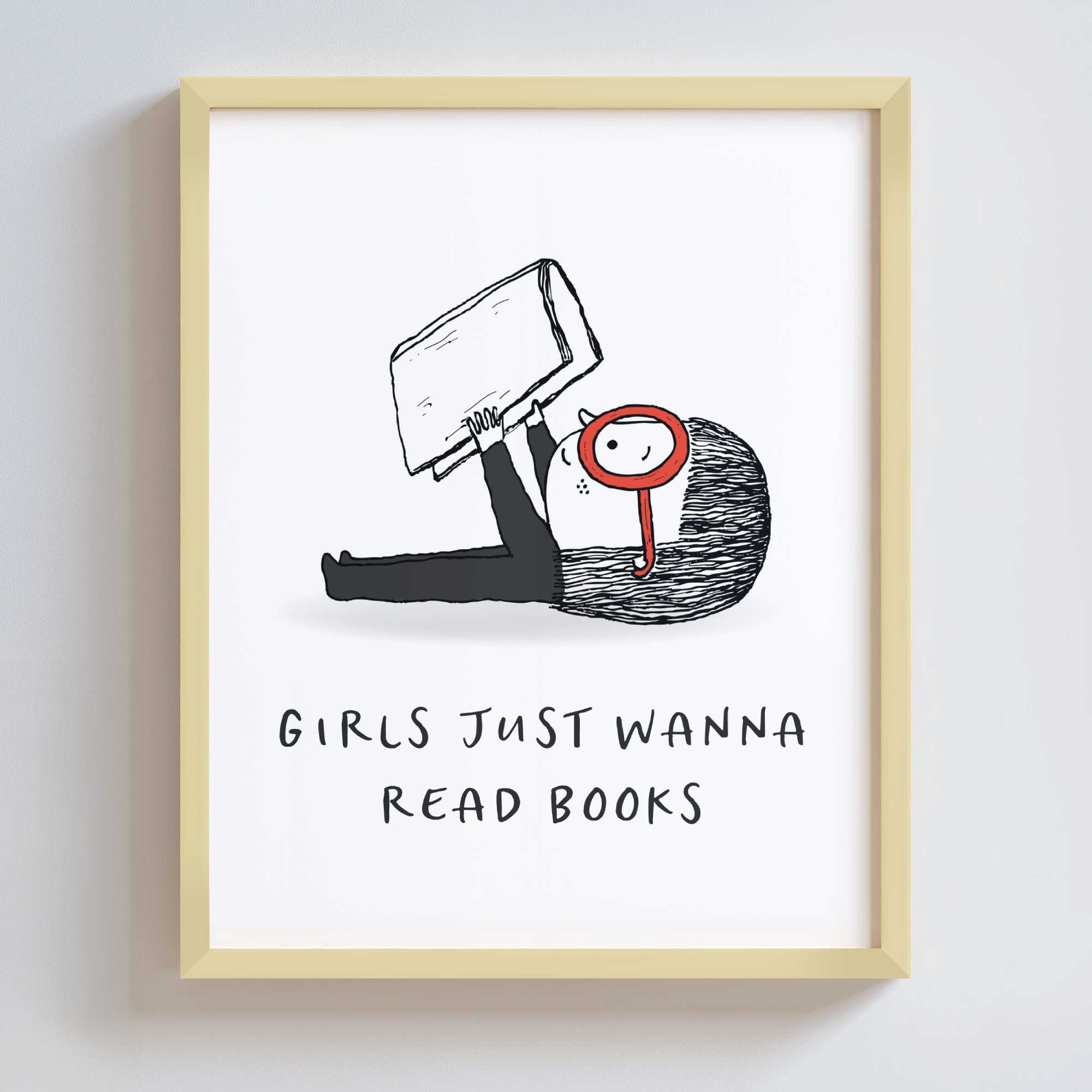Artwork in a gold metal frame with a black and white cartoon illustration of a girl holding a book, with text 'Girls just wanna read books' on a white background.