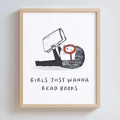 Wood-framed artwork with a black and white illustration of a girl holding a book and wearing large red glasses. Text underneath says 'GIRLS JUST WANNA READ BOOKS'.