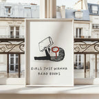 Framed artwork with an illustration of a girl holding a book and text 'Girls just wanna read books' against a European cityscape background.