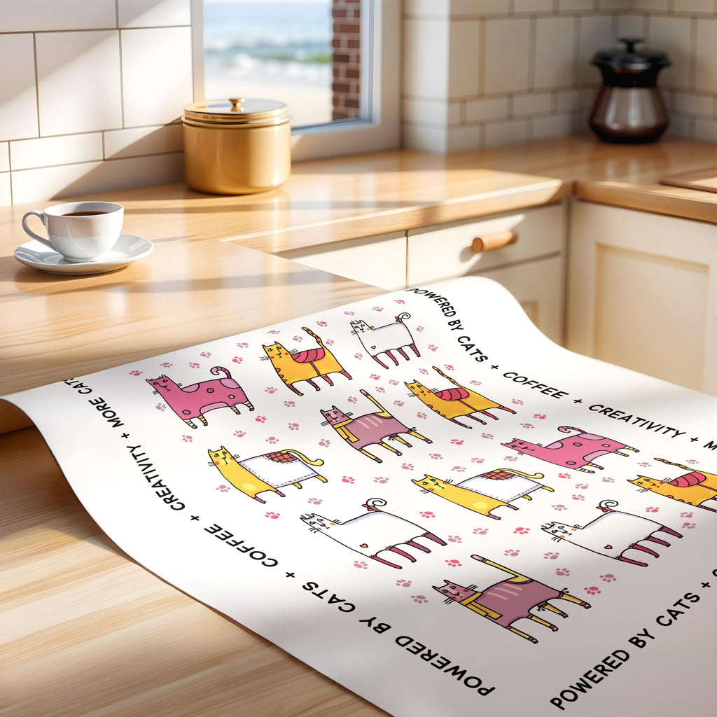 Unframed print with cat-themed design on a kitchen counter