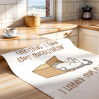 Poster with a cartoon cat illustration and text on a kitchen counter.