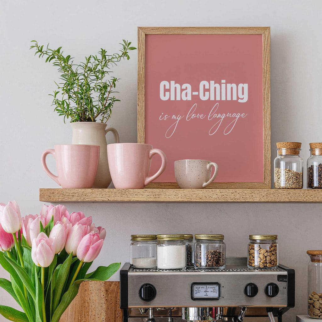 Shelf with pink mugs, a plant, a framed quote, and a small coffee machine.