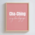 Framed pink poster in an oak frame with 'Cha-Ching is my love language' text on a white background