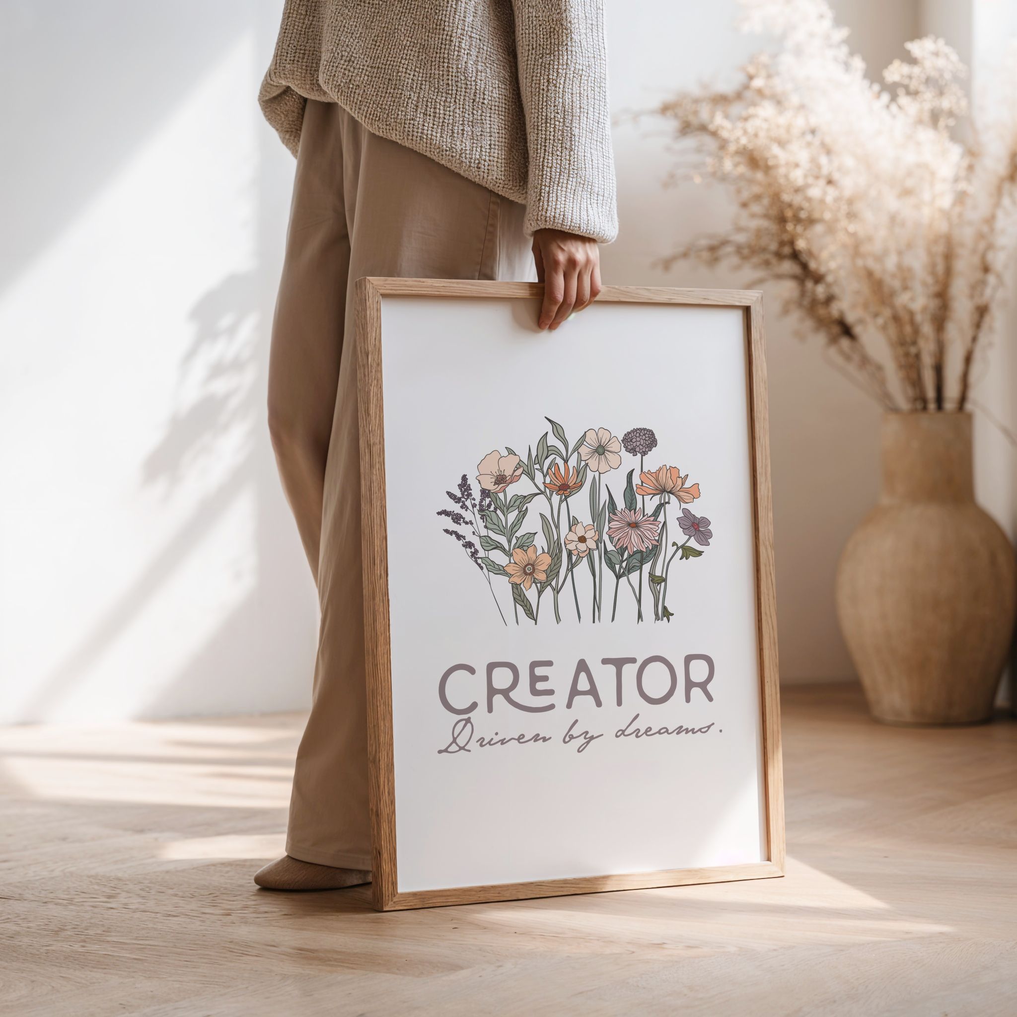 Woman carrying a framed print with floral design and text in a home setting