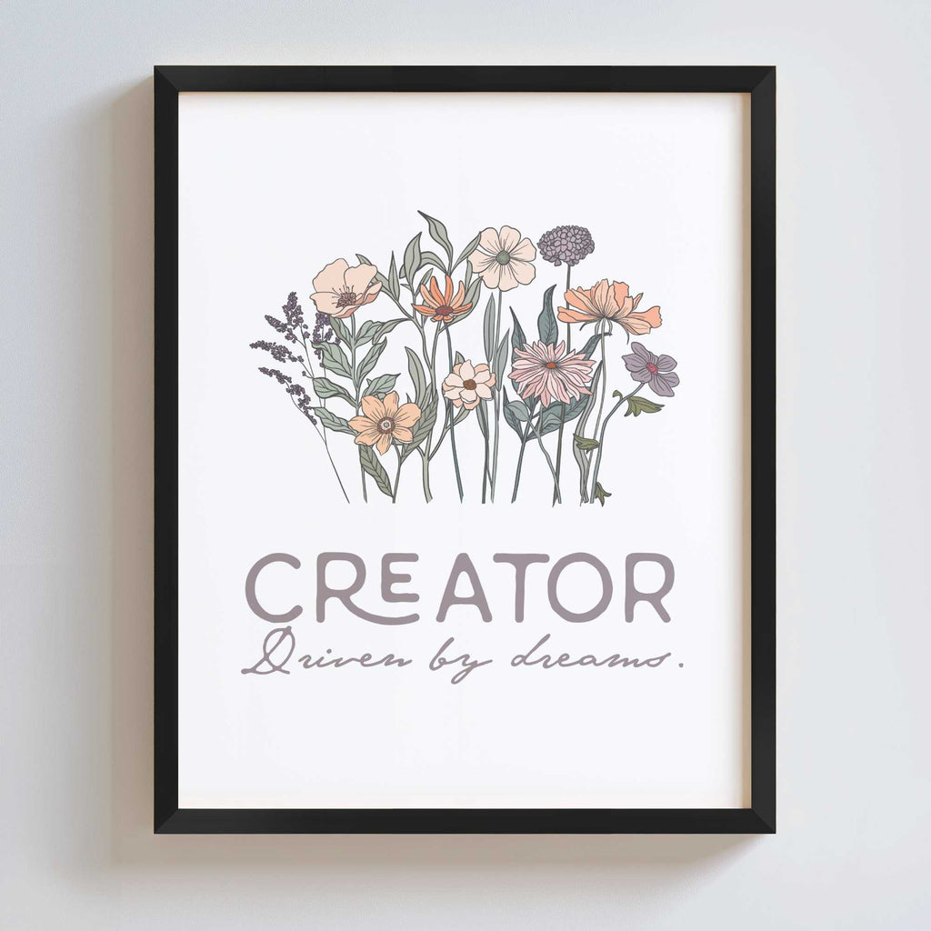 Black frame displays artwork with floral design and text 'CREATOR Driven by dreams.' on a white background
