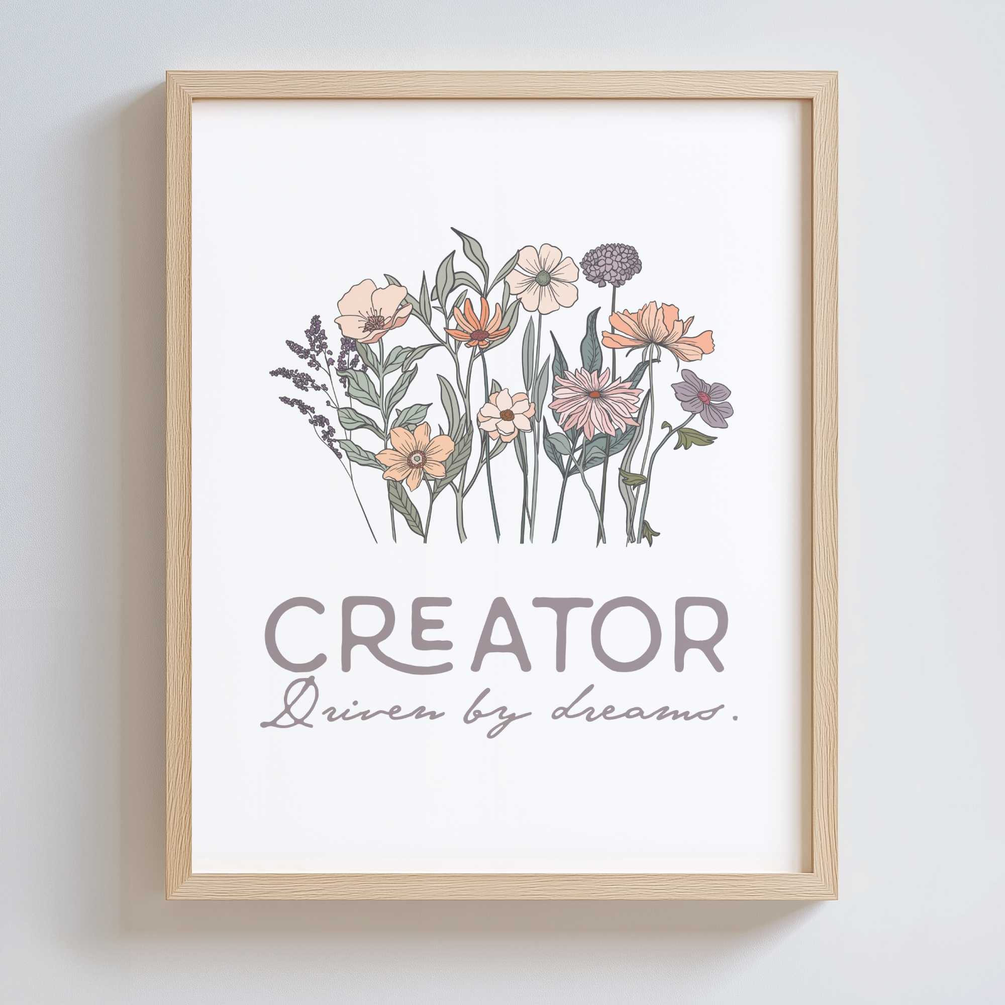 Framed artwork with floral design and text 'CREATOR Driven by dreams.' on a white background