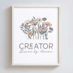 Framed artwork with floral design and text 'CREATOR Driven by dreams.' on a white background