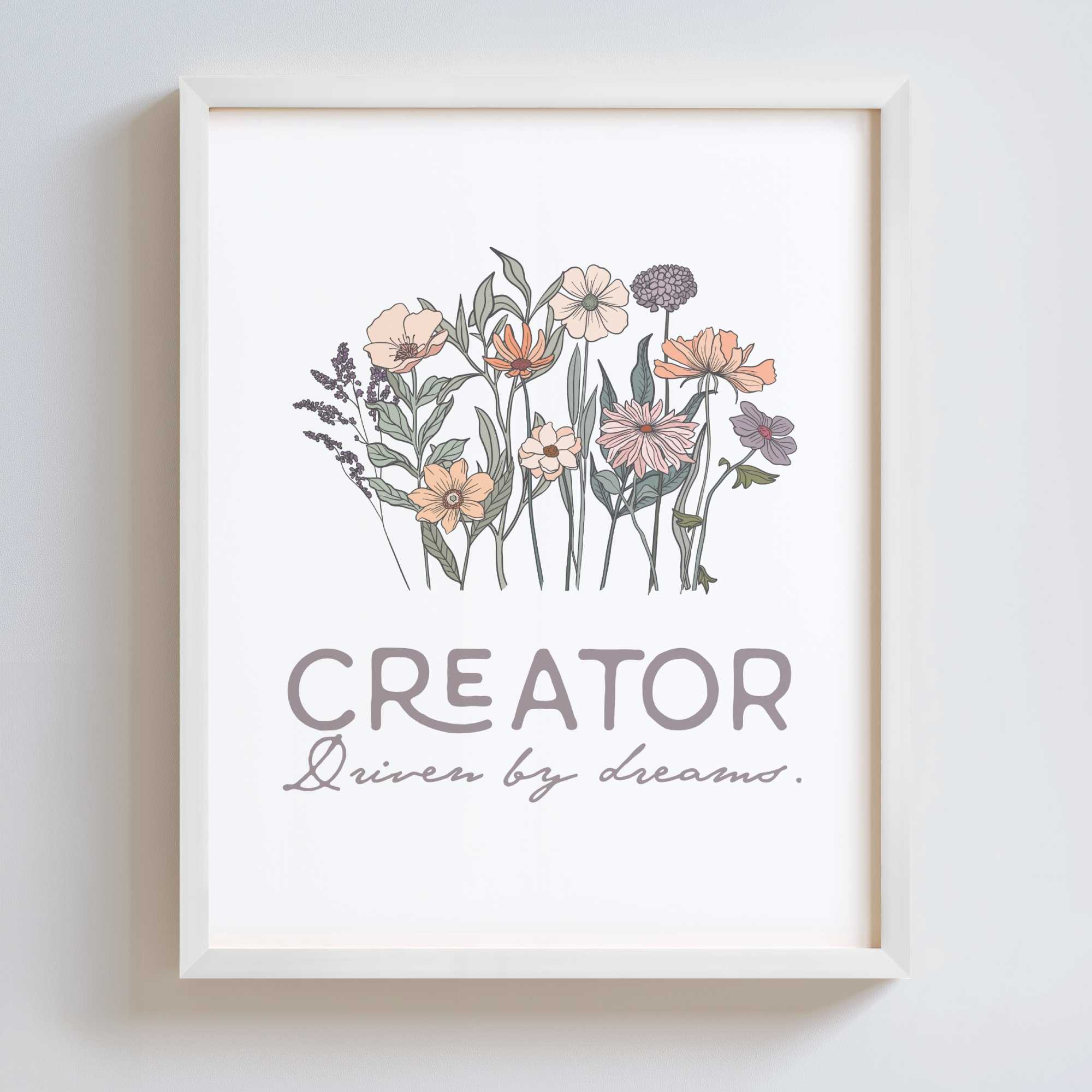 Framed artwork with floral design and text 'CREATOR Driven by dreams.' on a white background