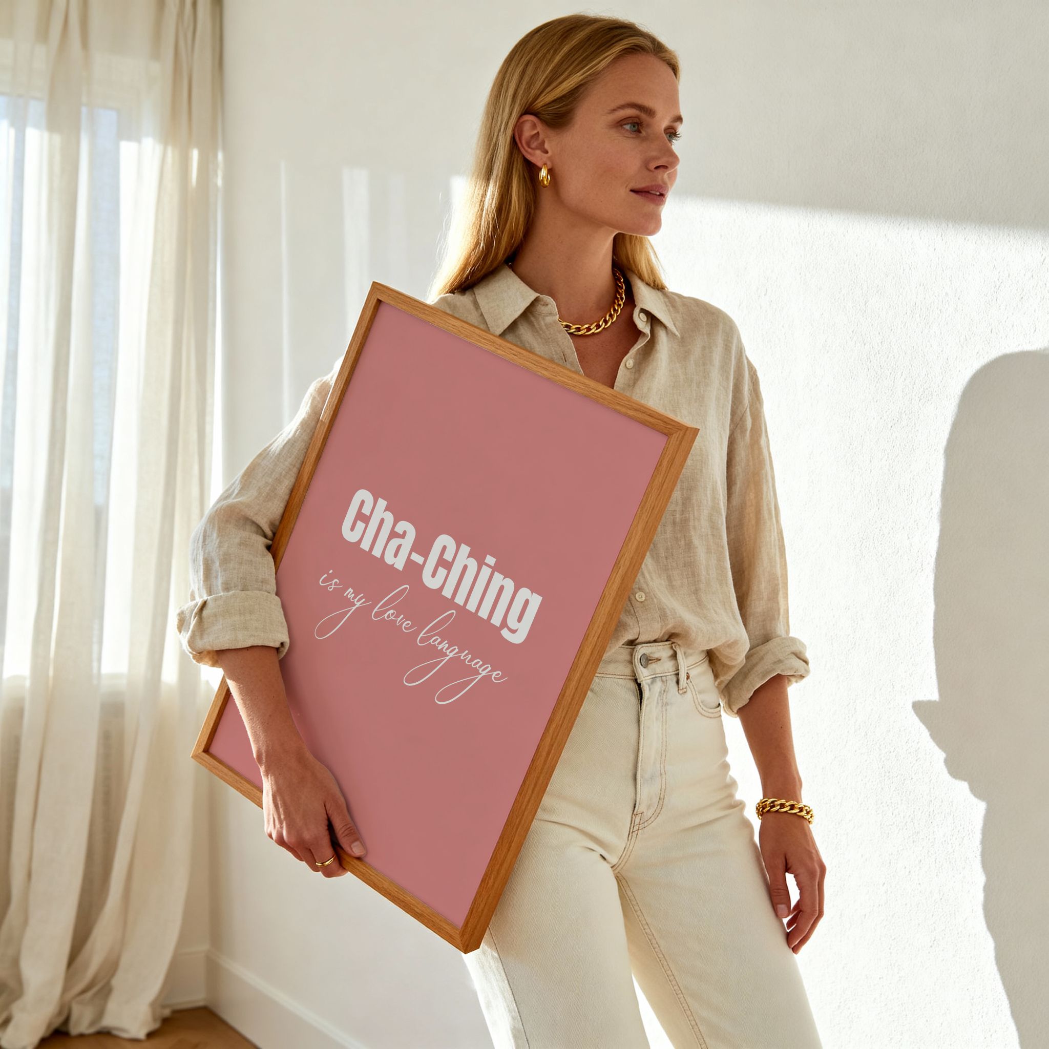 Woman holding a framed pink sign with text in a bright room