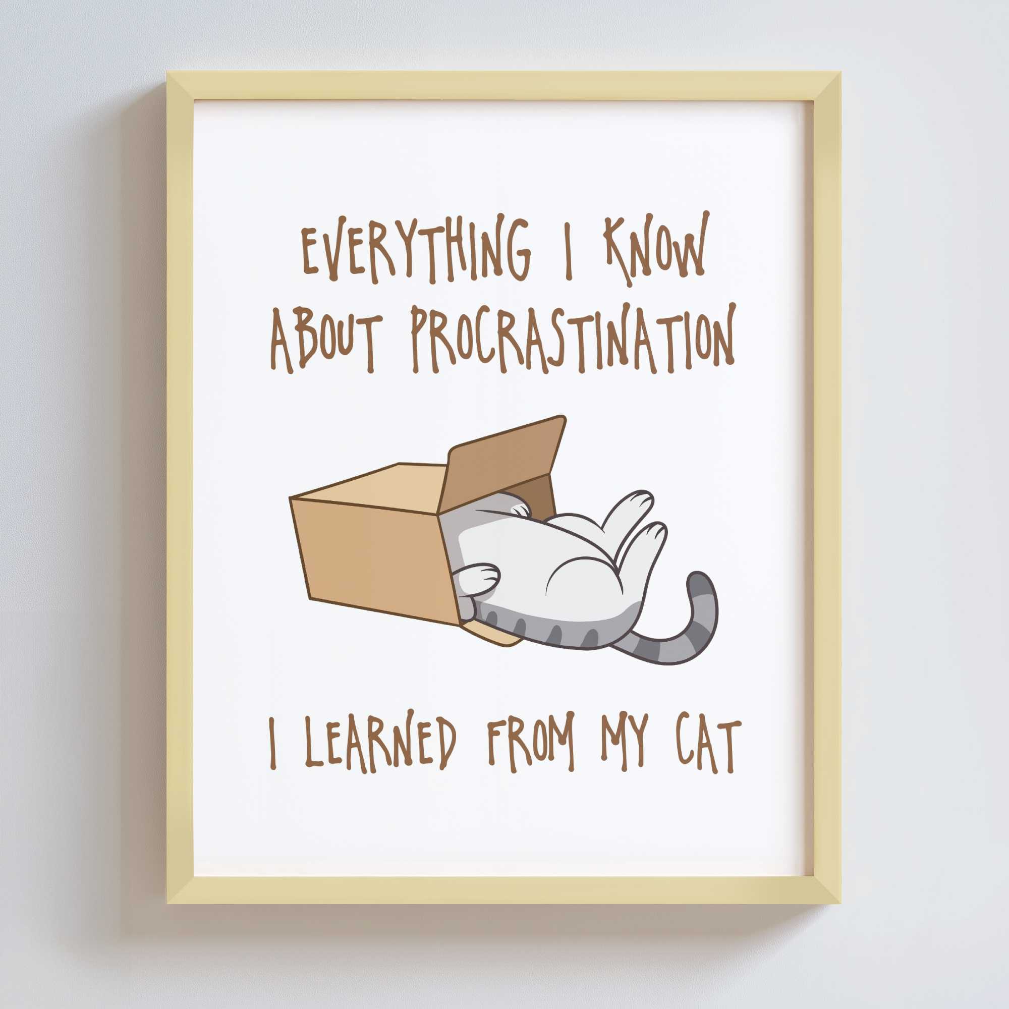 Framed print in a gold metal frame with a cat illustration and humorous text on a white background