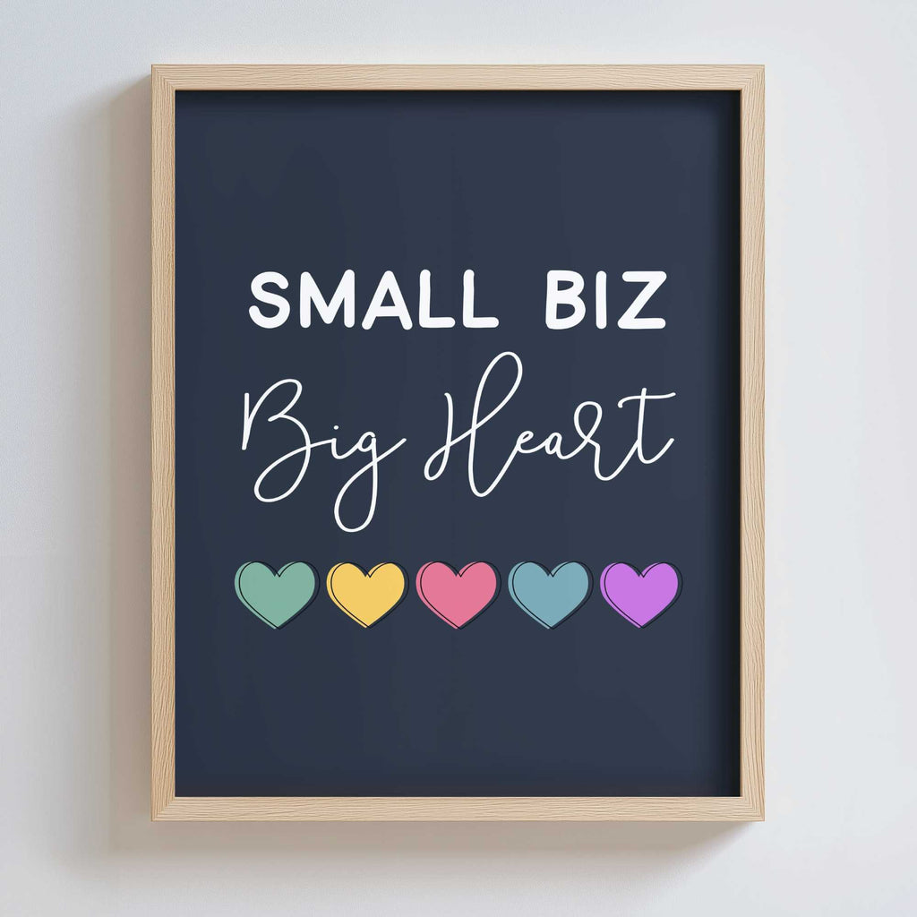 Framed artwork with 'Small Biz Big Heart' text and colorful hearts on a dark background