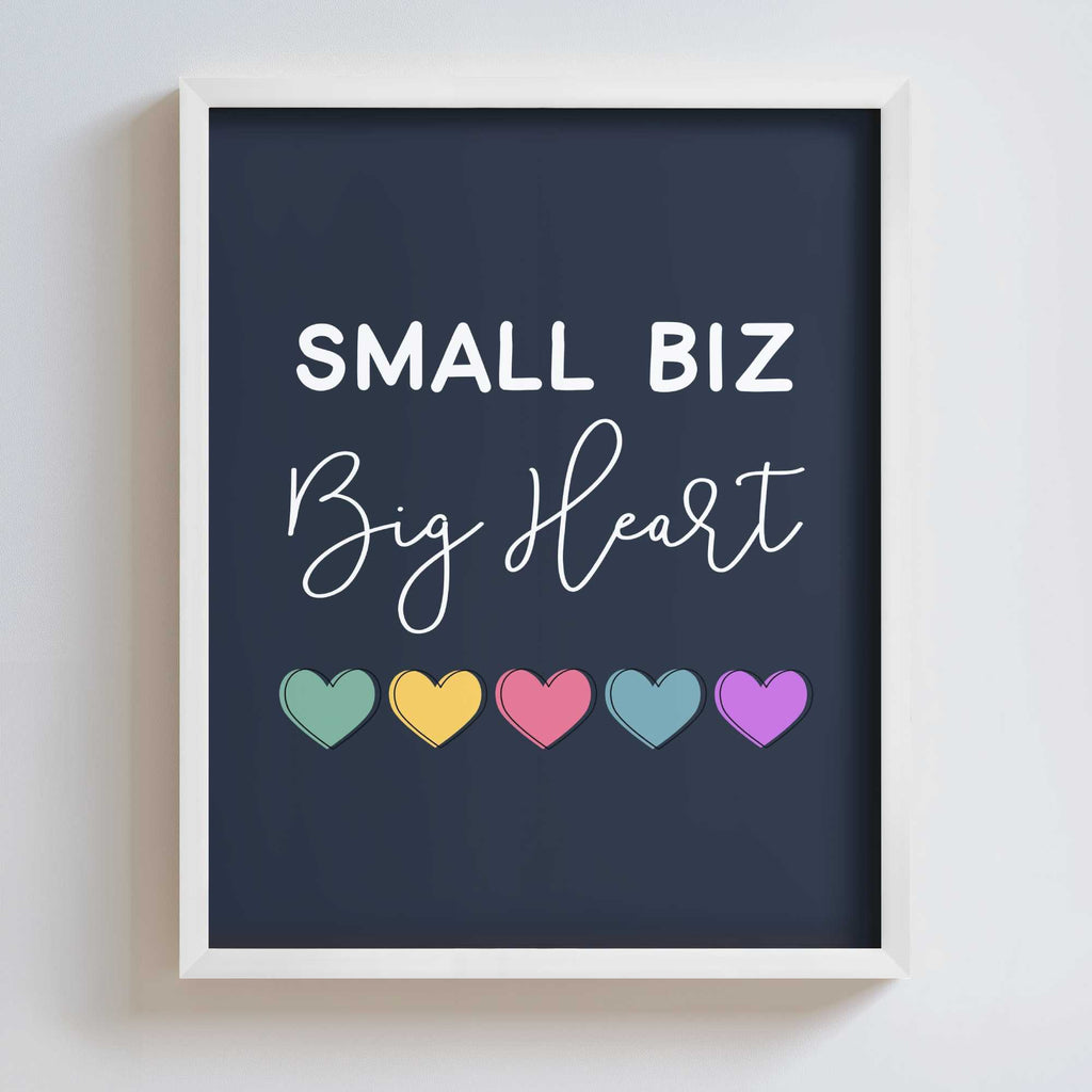 Framed artwork with 'Small Biz Big Heart' text and colorful hearts on a dark background